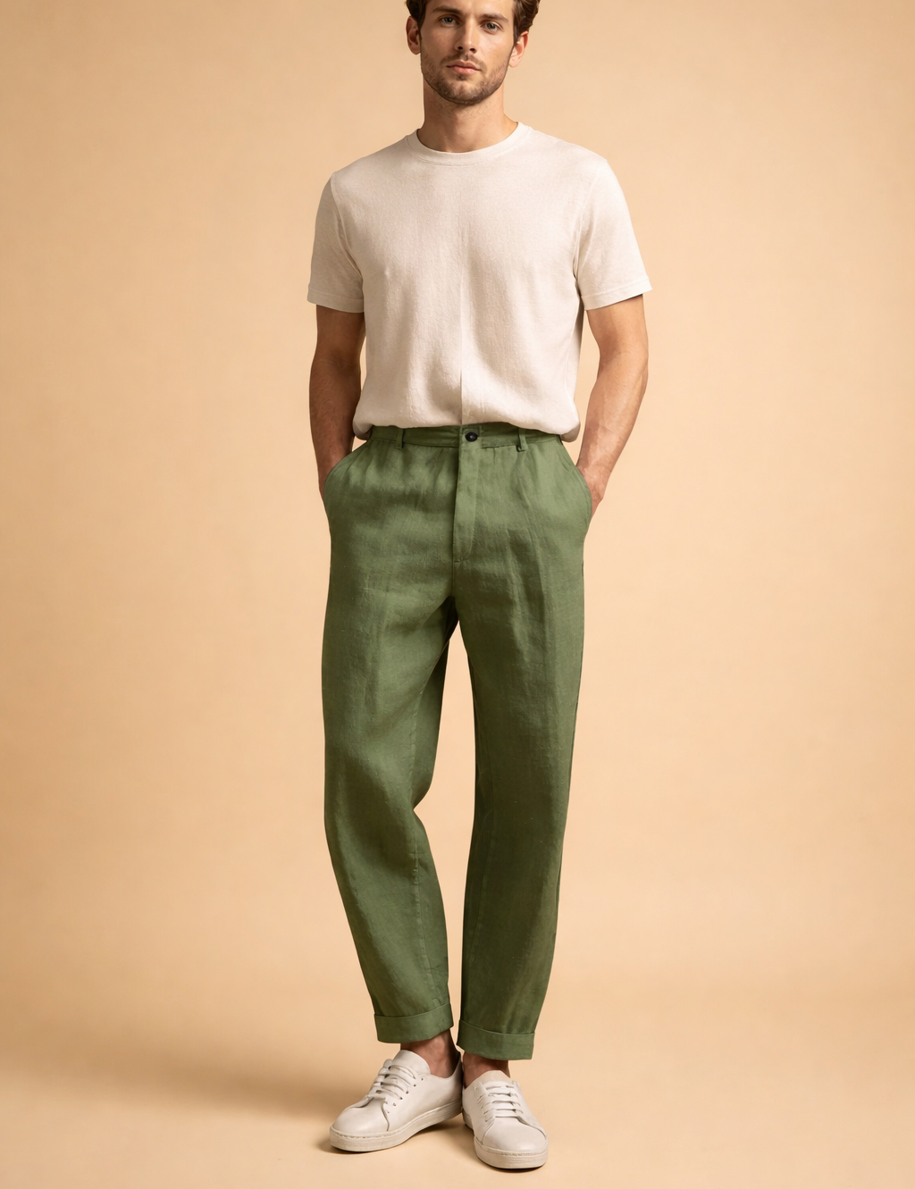 Tailored slim-fit men’s trousers with a clean front, straight tapered legs, ankle-length finish, smooth structured drape, discreet waistband closure, and minimal detailing, styled with low-profile sneakers for a modern refined look.