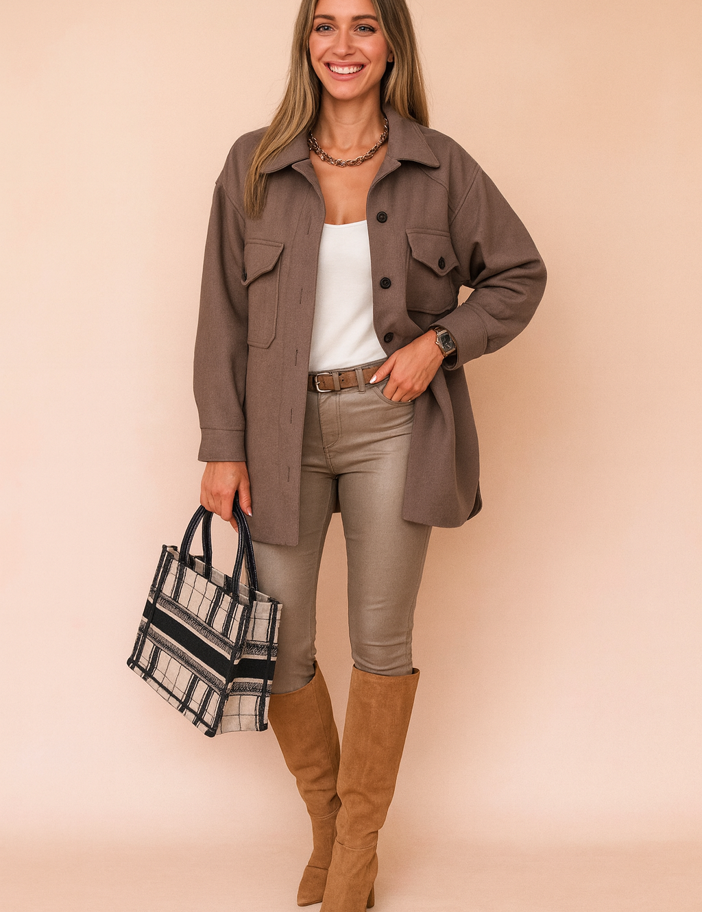 Taupe-brown button-up jacket with flap pockets and dark buttons, styled with a white top, slim beige pants, camel suede knee-high boots, and a plaid structured handbag.