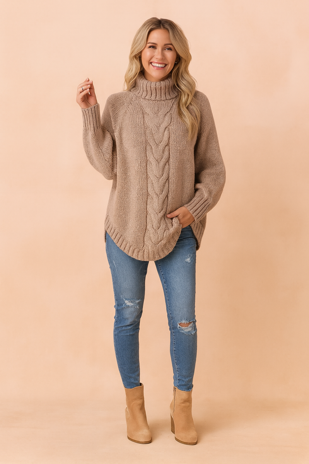 Taupe chunky knit turtleneck sweater with a central cable pattern, ribbed cuffs and hem, paired with distressed light blue skinny jeans and tan suede ankle boots.