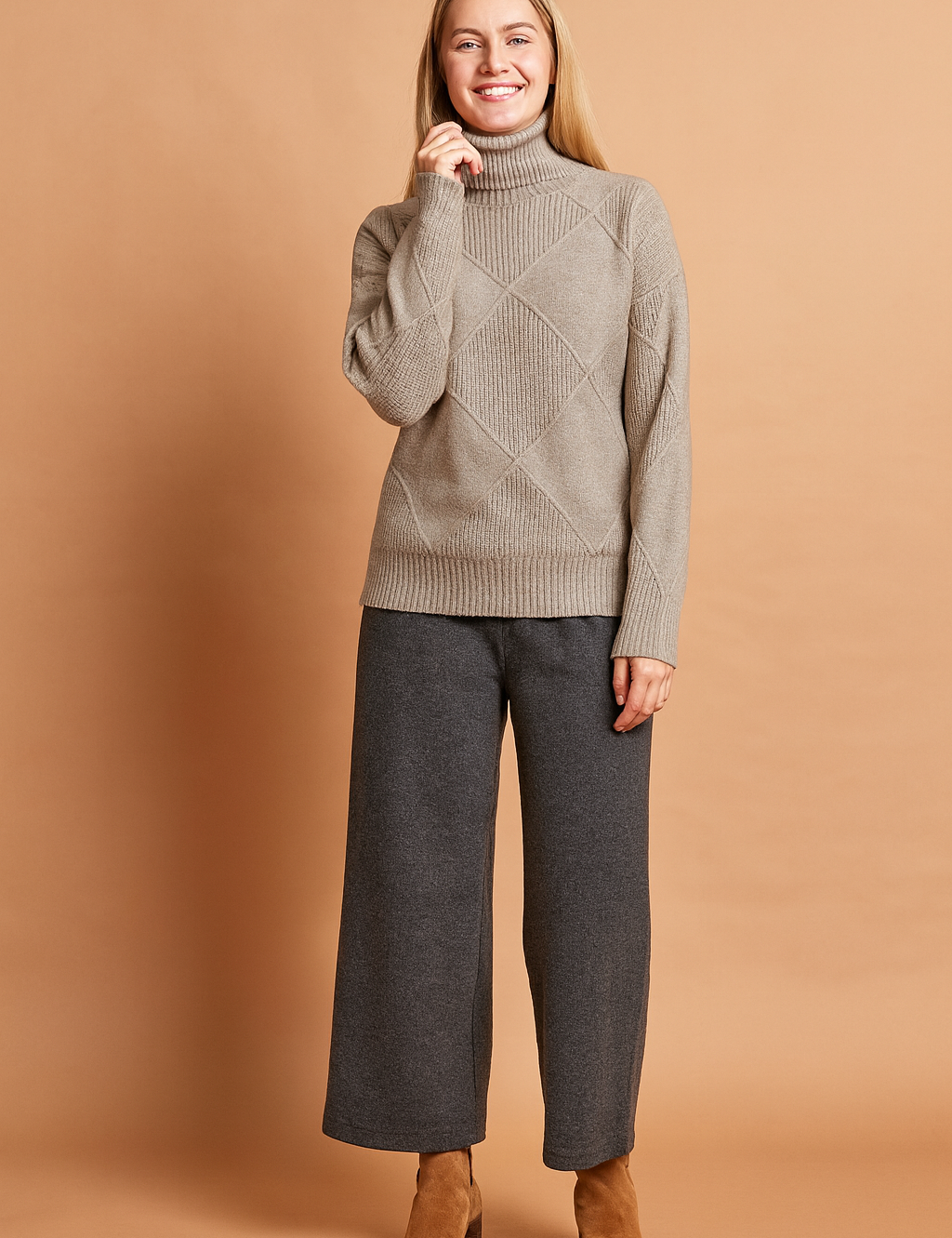 Taupe turtleneck sweater with textured geometric diamond knit pattern, ribbed cuffs, and hem.
