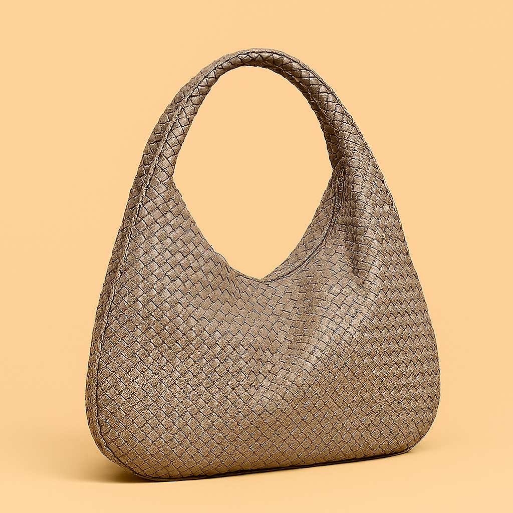 Taupe woven leather hobo bag with a slouchy crescent silhouette and braided top handle, styled on a warm beige backdrop for a minimalist fashion look.