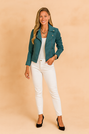 Teal biker jacket with silver snap buttons and zip details, styled over a white top and paired with slim-fit white pants and black heels.