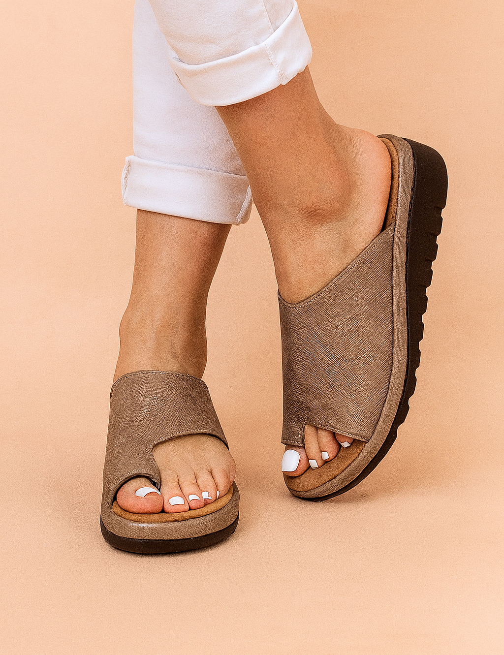 Textured taupe open-toe slide sandals featuring a wide asymmetrical upper with a subtle crosshatch linen-like pattern, raised platform sole in layered tan and black, and deep tread grip for added traction.