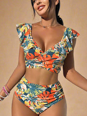 Two-piece tropical print bikini featuring a high-waisted bottom and a deep V ruffle-shoulder top, designed in a vivid mix of orange, yellow, green, and navy botanical patterns for a bold summer-ready look.
