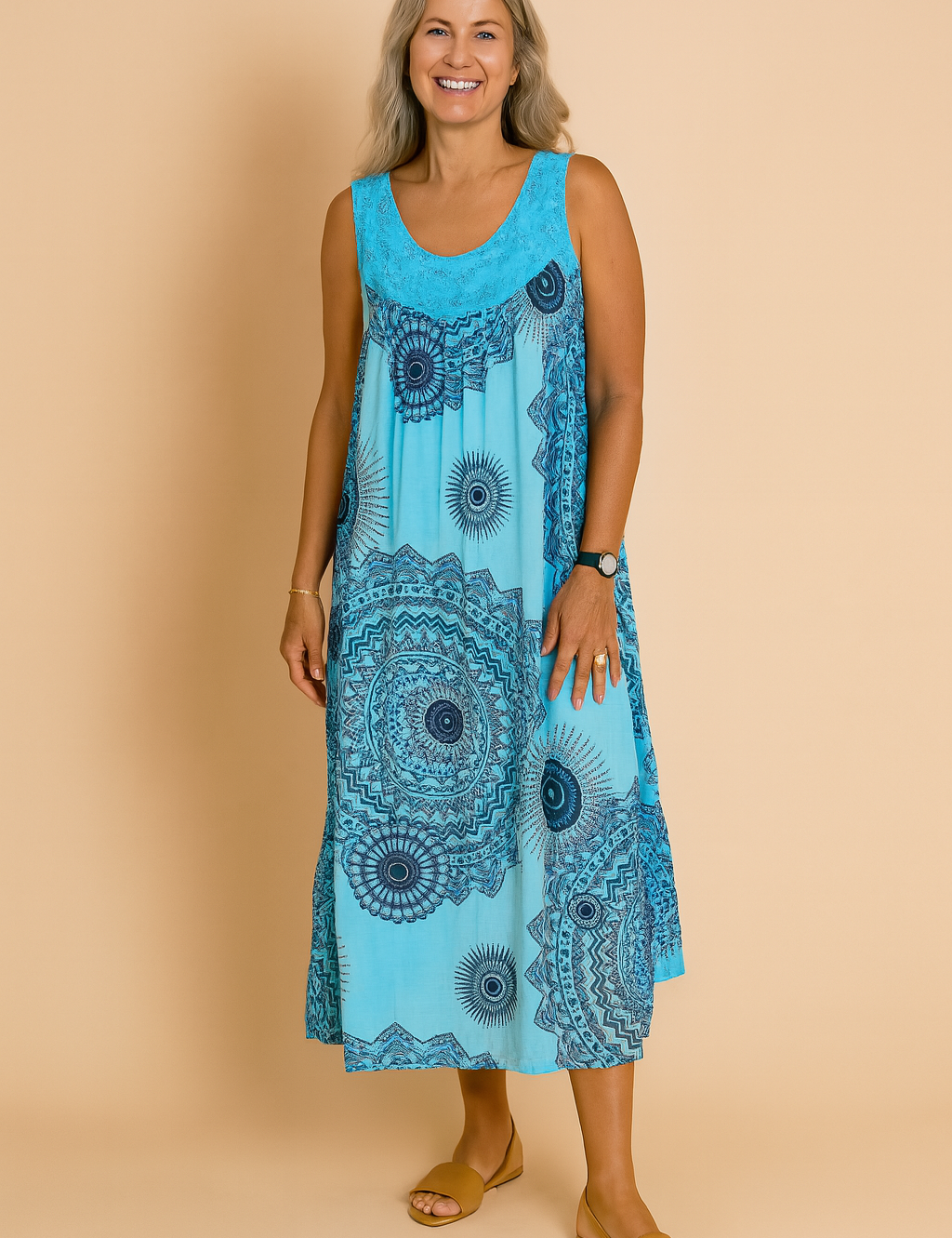 Flowy turquoise sleeveless sundress featuring bold navy mandala prints and a relaxed A-line silhouette, designed for a breezy, bohemian summer look.