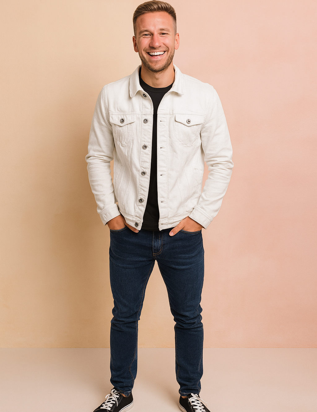 White denim button-up jacket with front flap pockets styled over a black shirt, paired with dark blue slim-fit jeans and black sneakers.