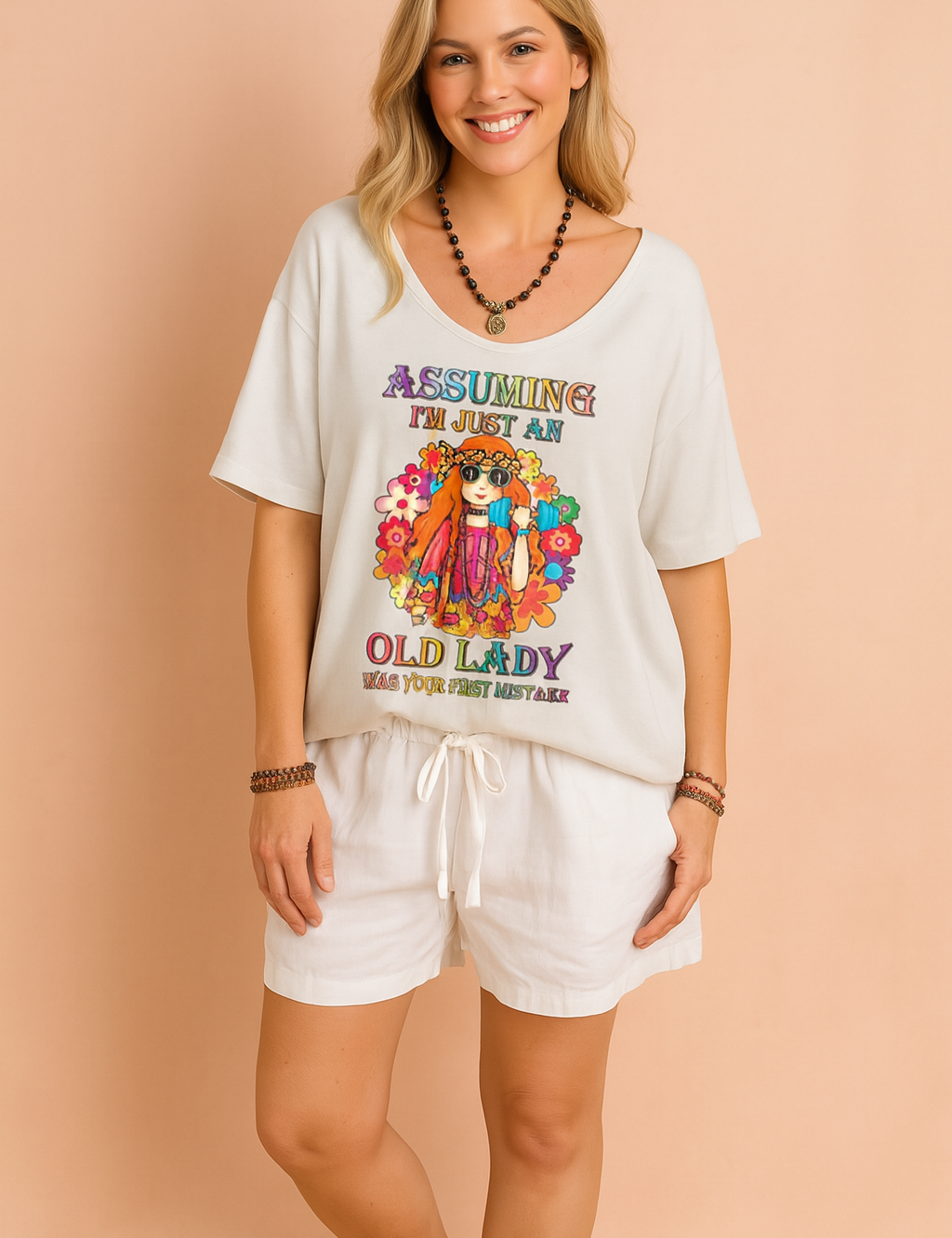 Loose-fit white T-shirt with colorful hippie-style graphic and bold text, paired with white drawstring shorts, perfect for a relaxed and playful summer look.
