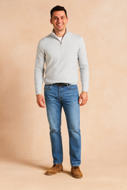 Men’s white half-zip pullover sweater with ribbed cuffs and hem, paired with straight-fit blue jeans and brown chukka boots, designed for a clean and versatile casual style
