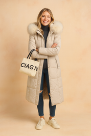 Long white winter parka coat with large fur-trimmed hood, quilted pattern styled with sneakers
