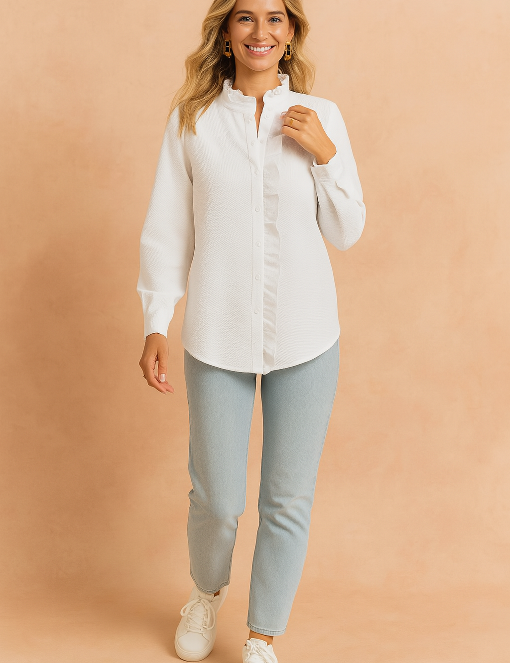 Textured white button-up blouse with a ruffled stand collar and concealed placket, paired with light-wash slim jeans and white sneakers.