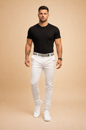 Slim-fit white pants with a tailored silhouette, clean front seams, structured waistband with a woven belt, tapered legs, and crisp white low-top sneakers for a modern smart-casual look.