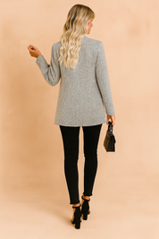 Women’s longline grey textured open-front jacket with subtle herringbone pattern, styled with slim black pants and block-heel sandals.