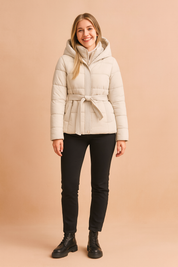 Women’s off white short hooded puffer jacket with waist belt, front zipper, and quilted design, offering a warm and stylish winter outerwear option.