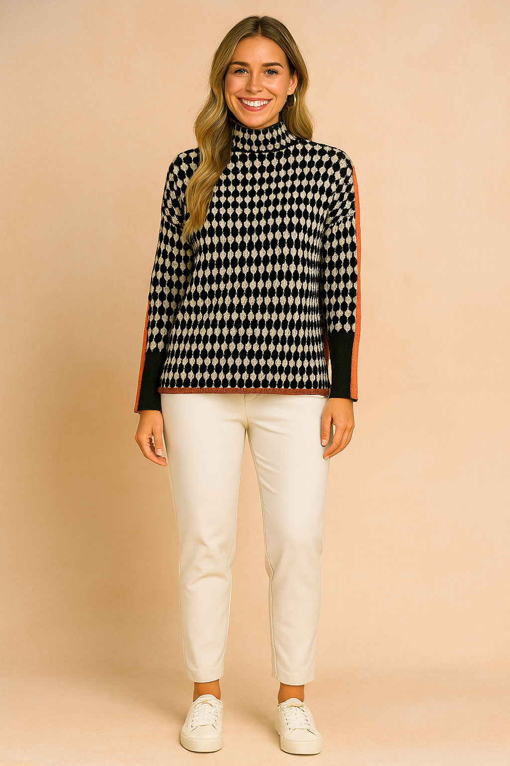 Oversized houndstooth turtleneck sweater with bold orange stripe detailing on sleeves, paired with black jogger pants and white sneakers.