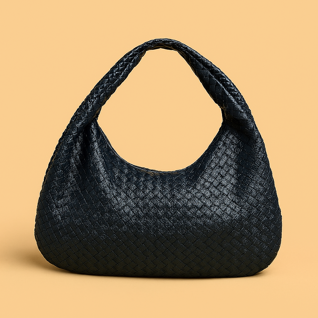 Navy blue woven leather hobo bag with a braided top handle and slouchy crescent silhouette, set against a beige background for a refined, artisanal look.